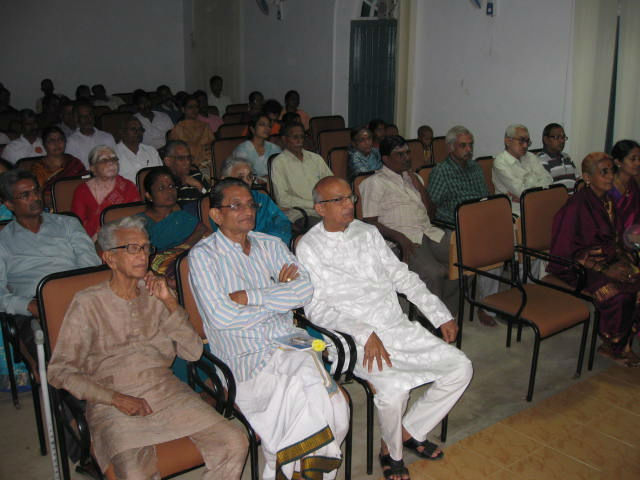 Audience engrossed in the video presentation